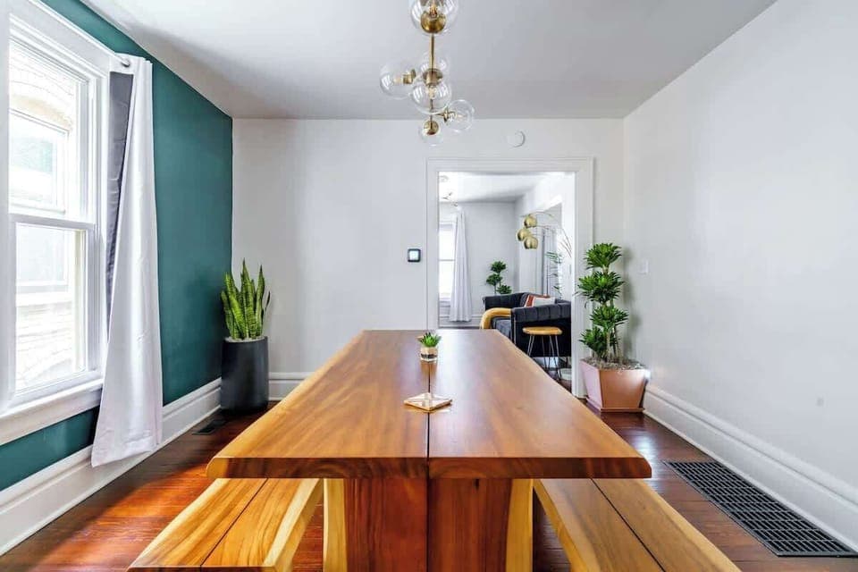 Family Meals, Group Style: Enjoy meals together in this spacious dining area, featuring a large table and seating designed for families and groups. A simple yet elegant space