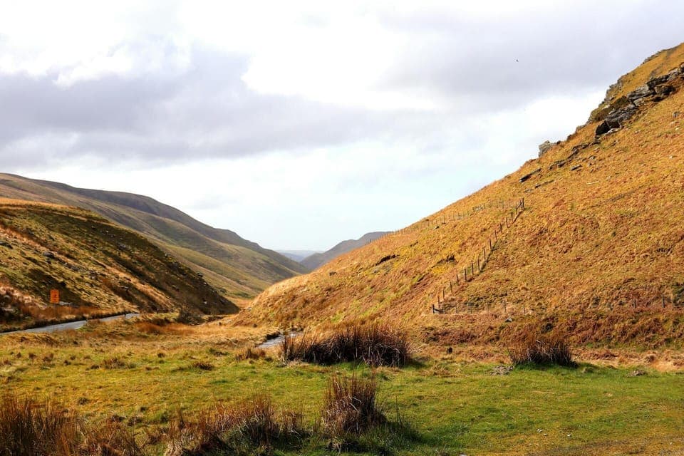 Valley and country road surrounded by hills