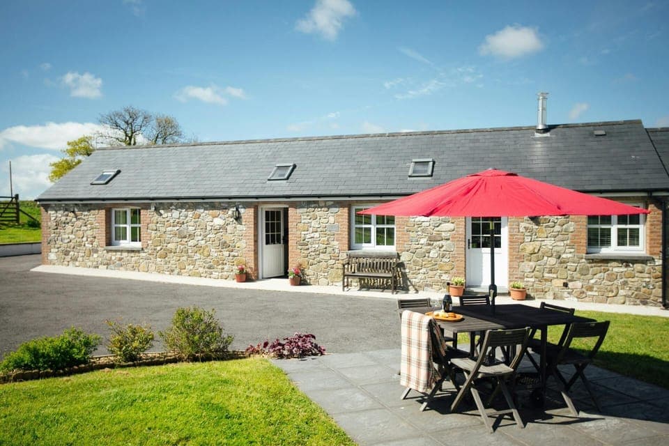 Beudy Nel with tarmac drive, paved patio with table, six chairs, parasol and lawn