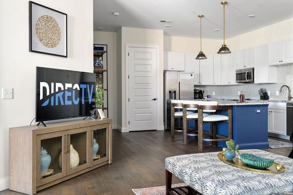 Open concept main living area with large designer kitchen and beautiful Arhaus furniture. 