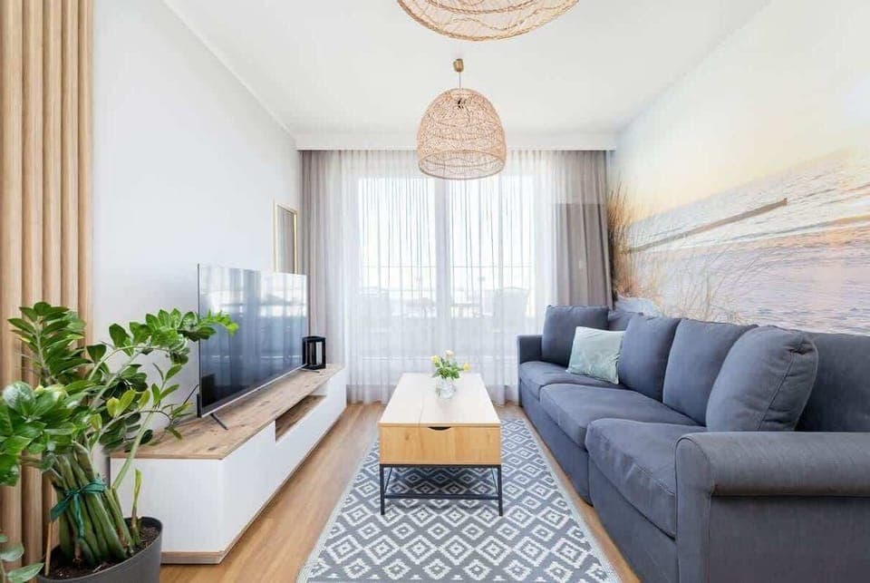 Relax in the stylish living room with a comfortable sofa and modern decor.