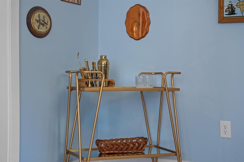 Beverage cart with cocktail shakers and glasses