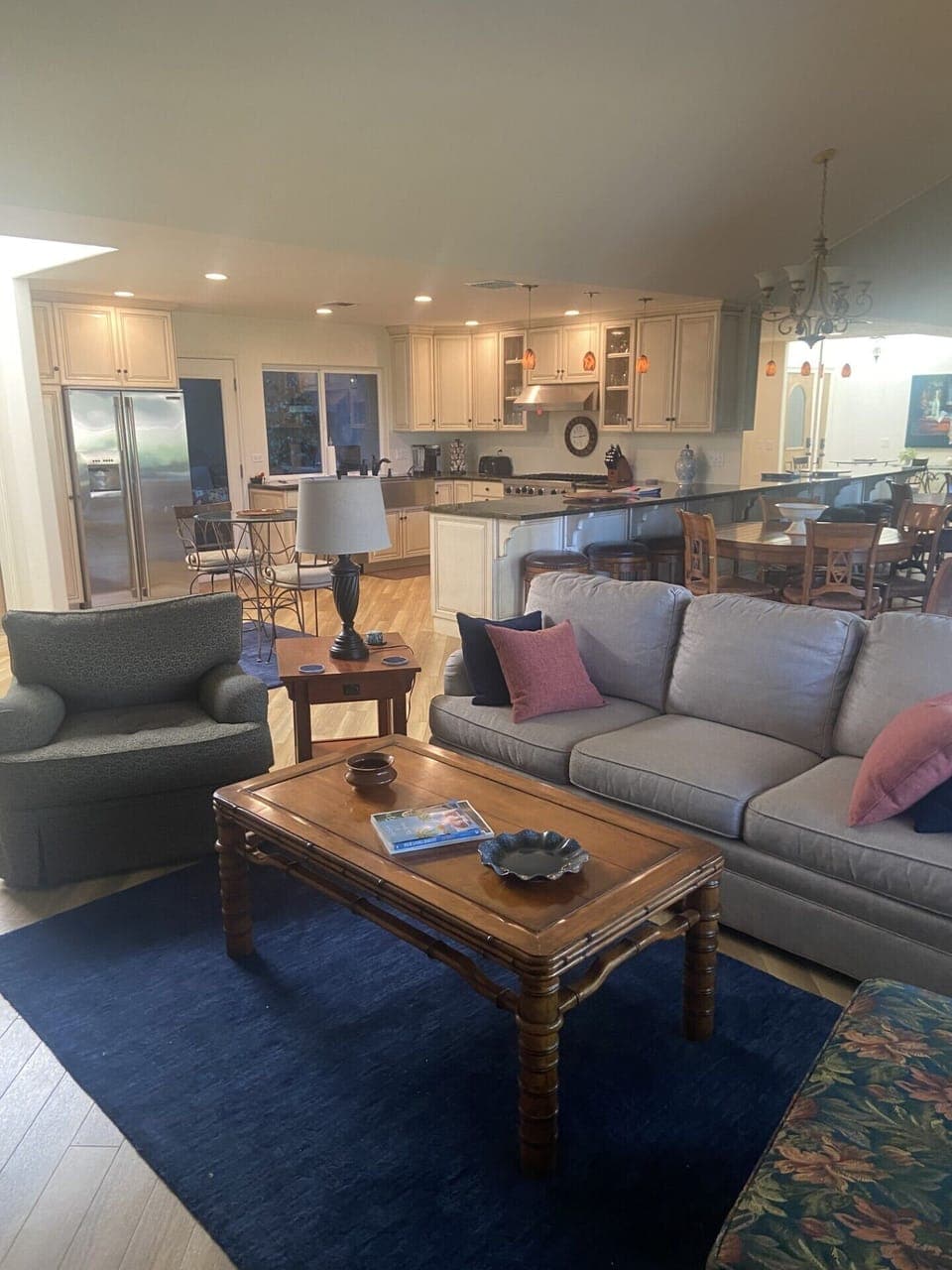 Living room with sofa, two lounge chairs, recliner, and large smart TV