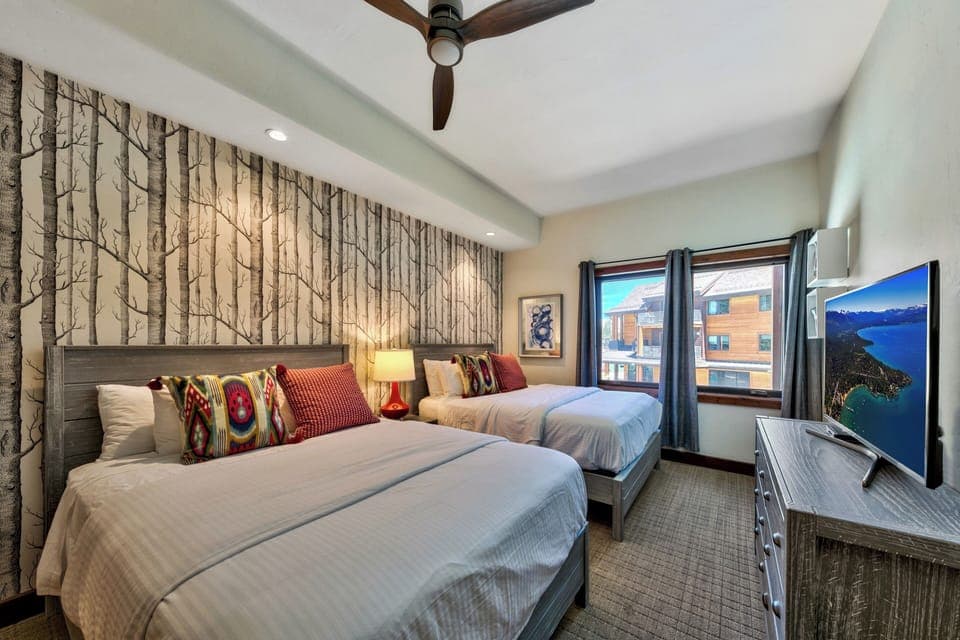 2nd bedroom with two queen beds, big screen HDTV, and plenty of clothing storage