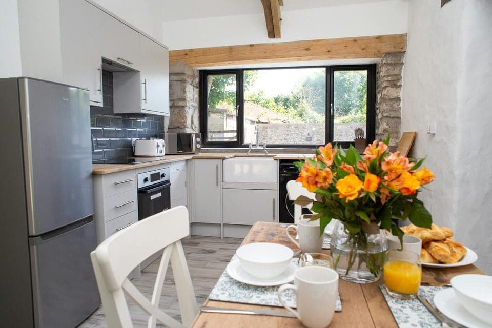 Kitchen with fridge freezer, oven and hob. Views over the garden