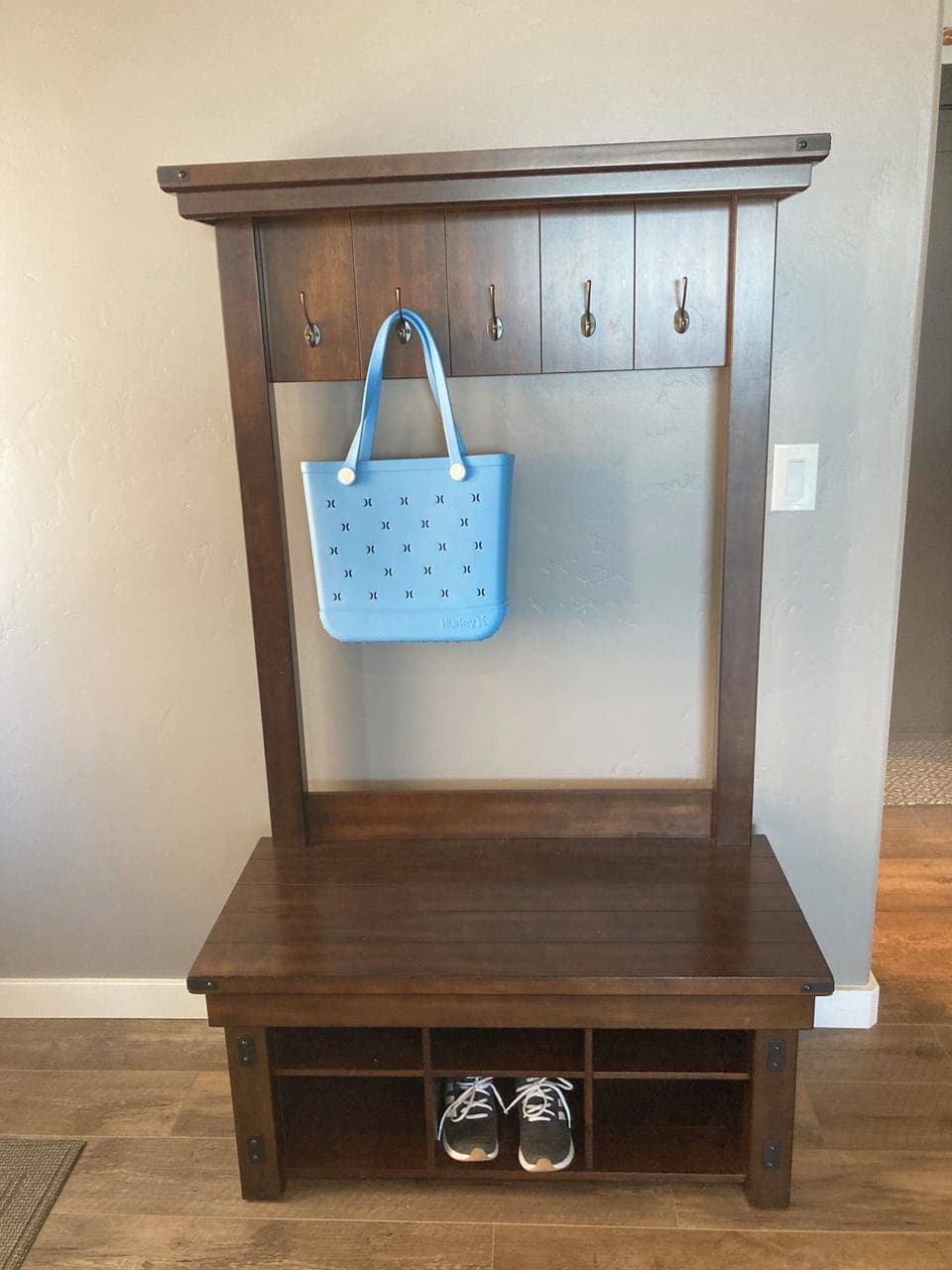 Bench by entry door for shoes, jackets, sweatshirts.