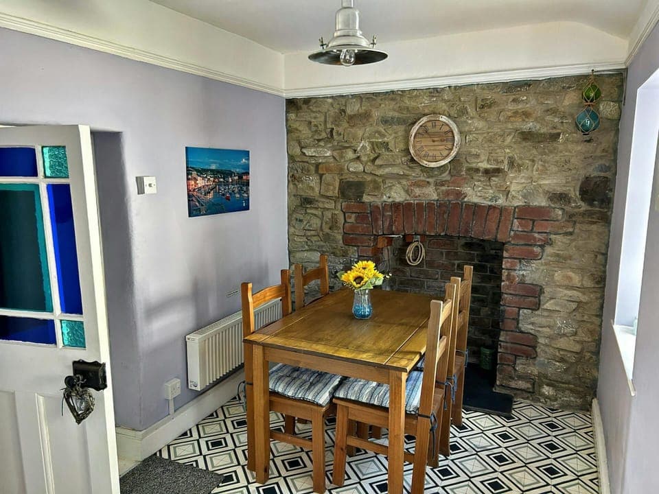 Dining room with table and four chairs and fireplace