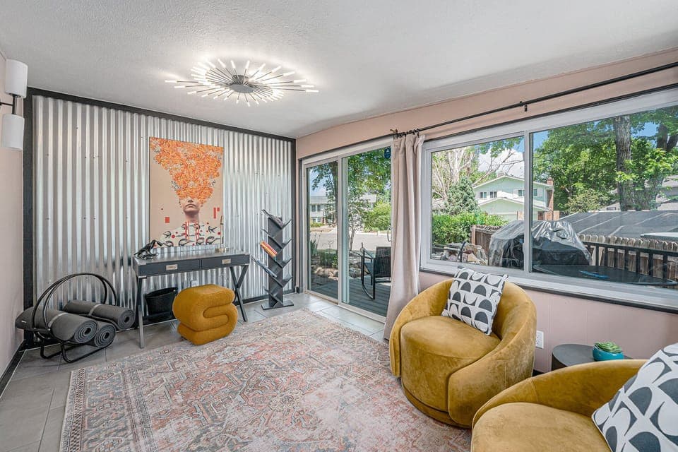 - Eclectic design with corrugated metal wall and modern art creates a bold vibe
- Functional workspace with yoga mats, a compact desk, and geometric bookshelf
- Sunlit corner with large windows and backyard access for a refreshing work zone