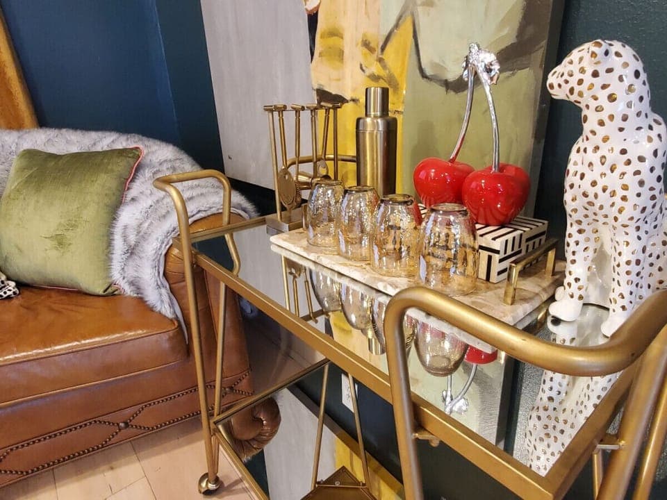 Rolling beverage bar stocked with glassware — perfect for cocktails and evening drinks