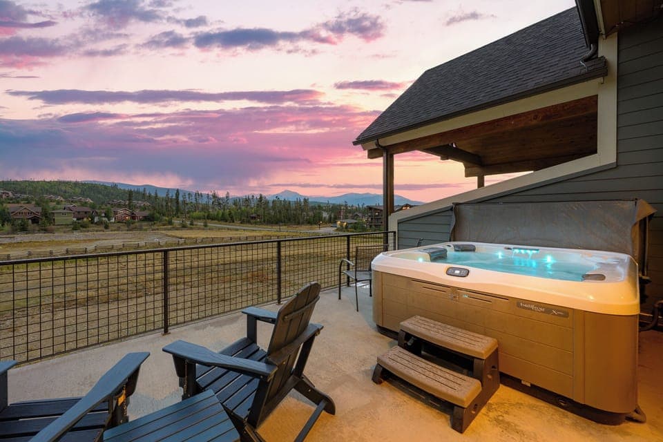 Soak away stress in the bubbling hot tub with breathtaking open sky mountain views - Elevated privacy wall and covered roof make it usable in any season or weather - Perfect for unwinding after hikes, slopes, or simply a relaxing day in nature