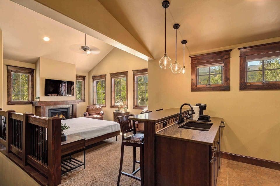 Bedroom 4: Lock off apartment, king bed, pull-out couch, dresser, 40” TV, gas fireplace, 2 lounge chairs, dedicated workspace, fully-equipped kitchen, en-suite bath, upper floor