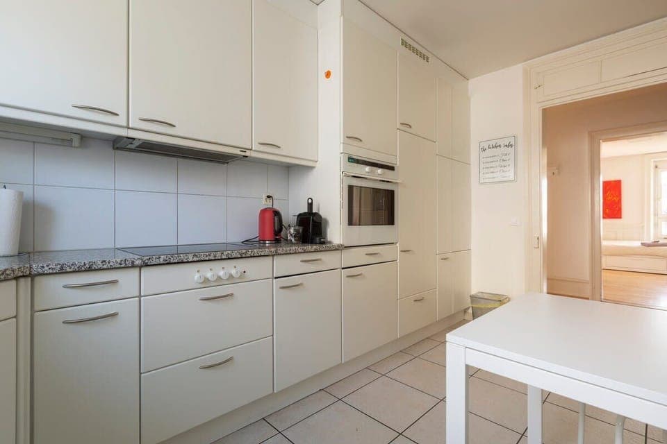 Bright and spacious kitchen with a big window and ample storage space -  fully equipped with dishwasher, fridge, microwave, oven, toaster, Nespresso coffee machine etc. 

A cozy table for casual dining or as additional tabletop space.