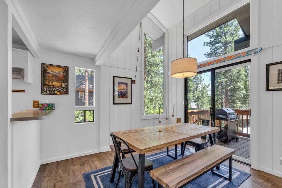 Dining Room: 6-person dining table, soaring windows, access to deck, located between the living room and kitchen