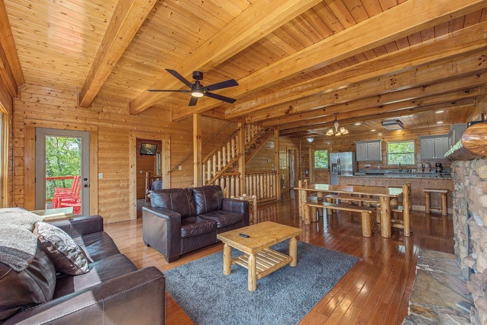 Relax in this stunning log cabin with exposed beams, leather seating, and open-plan design connecting living and kitchen spaces perfectly.