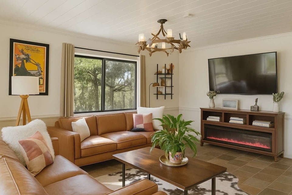 Kick back and relax in this cozy living room—comfy couches, big smart TV, and peaceful forest views.
