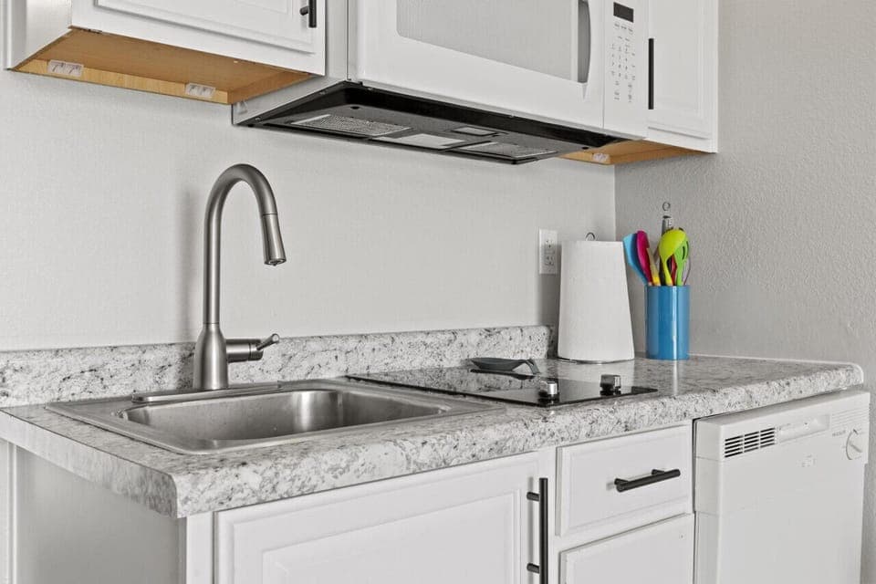 Perfect little kitchenette with 2 burner cooktop, microwave, and dishwasher.  We also have a crock pot.