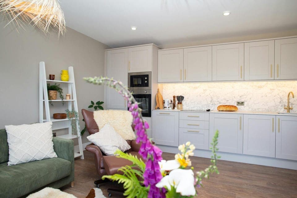 Living area with sofa, arm chair and shelving