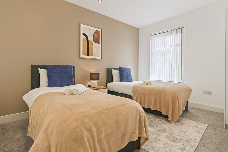 Bedroom 1 has twin beds with fresh linen and towels provided.