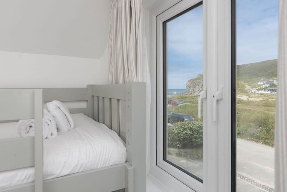 Castaways, Porthtowan. First Floor: Views towards the rugged cliffs and rolling waves of Porthtowan Beach