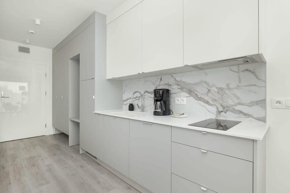 Bright kitchen with cooking utensils. 