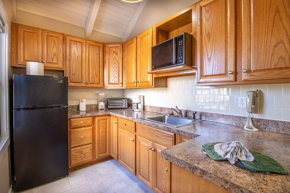 Partial kitchen includes refrigerator, microwave and toaster oven