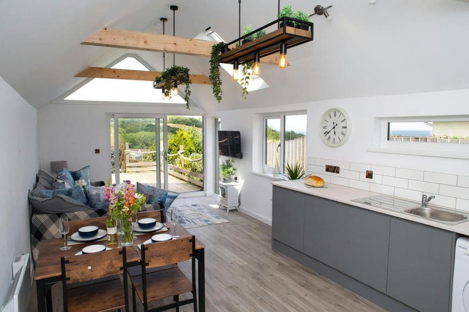 Open plan living area with patio doors leading to the deck