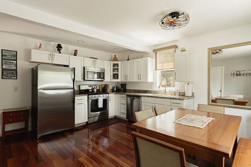 Open concept kitchen and dining space with seating for up to six at the dining room table.