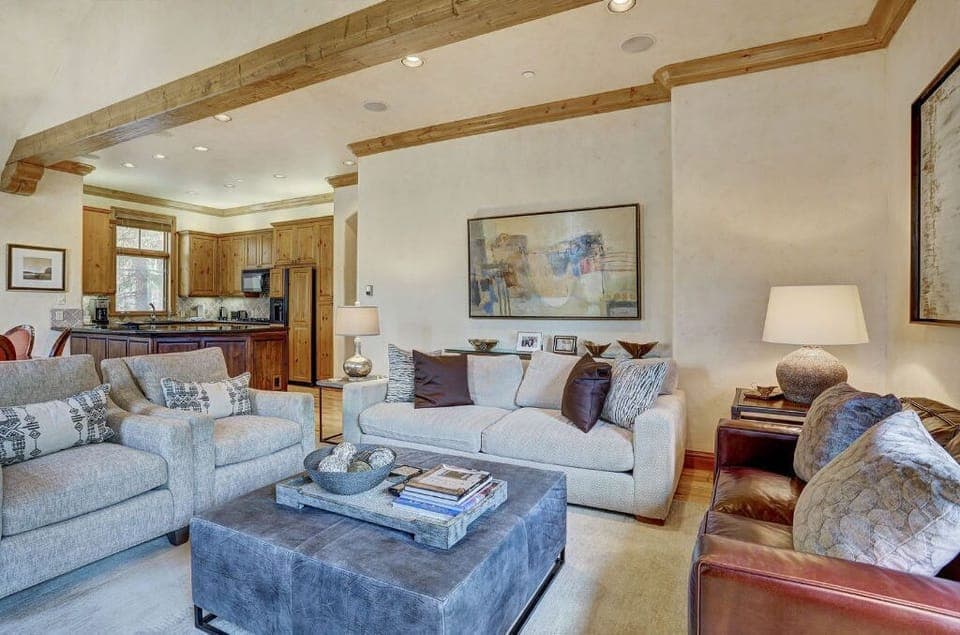Relax in the second living room, offering additional seating, a flat-screen TV, and a warm, inviting atmosphere perfect for gatherings.