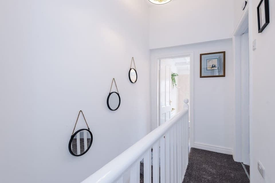The upstairs landing leads to both bedrooms and the bathroom.