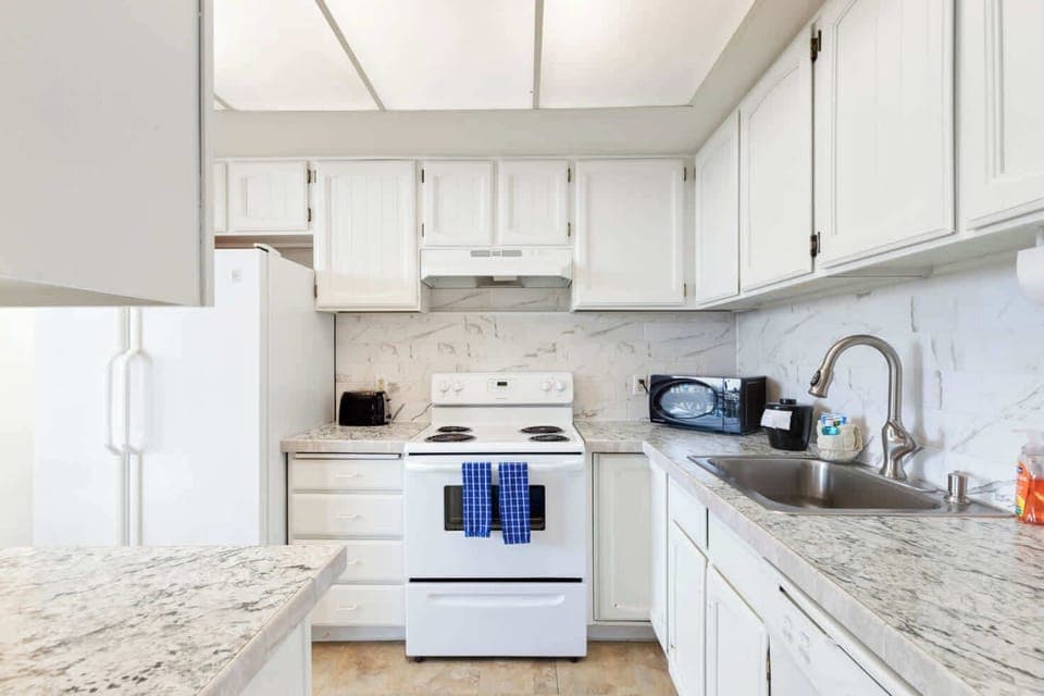 Functional kitchen providing essential appliances creating a clean and practical cooking space