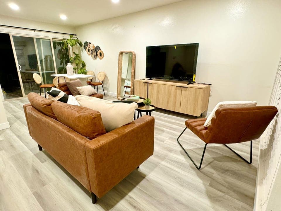 65" Smart TV, rustic vibe living area with full body mirror
