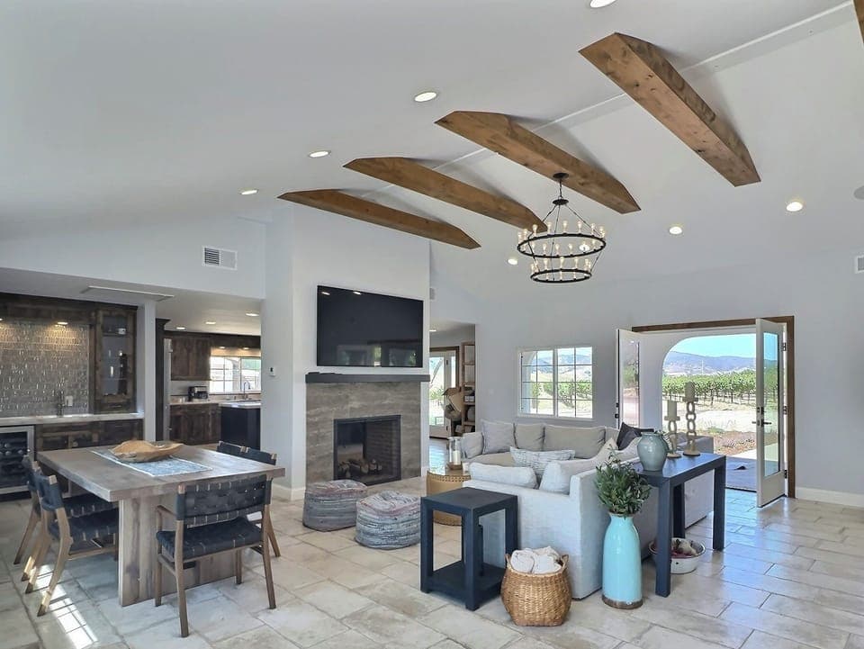 This stunning great room features a spacious and comfortable sectional sofa, perfect for lounging and socializing. The modern dining table, situated nearby, offers ample seating for family meals or gatherings.