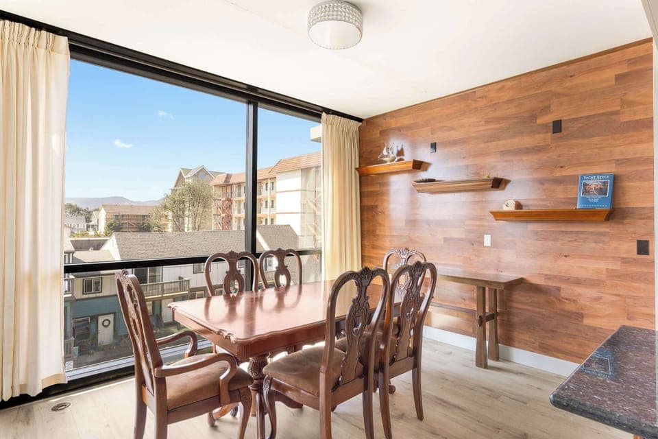 Gather around the table! Enjoy meals and conversation in this inviting dining space with large windows and natural light.