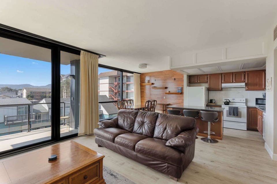 Open concept living with a private balcony! Enjoy easy access to a full kitchen and dining, perfect for your vacation stay.