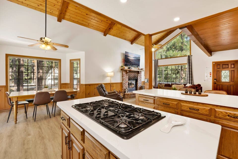 Kitchen opens to dining table which seats 6