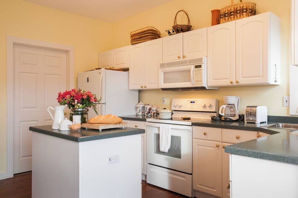 Sleek, fully equipped kitchen featuring stainless steel appliances, quartz countertops—great for casual meals or socializing.