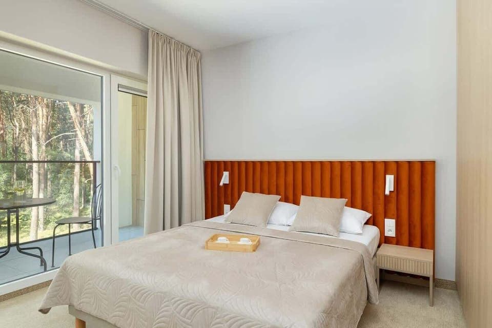 Bright living room with forest view – Relax with nature right outside your window.

