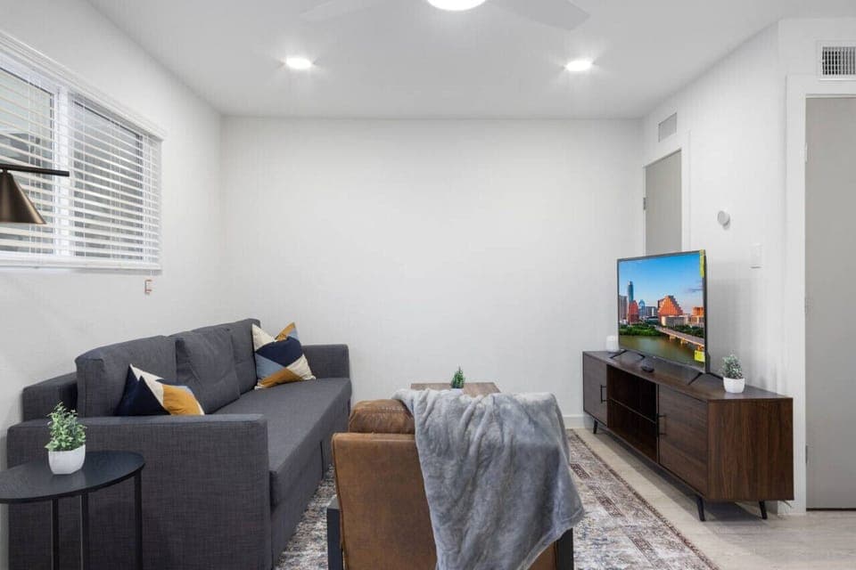 You feel at home as you settle into the living room, where the inviting atmosphere is perfect for lounging or entertaining.