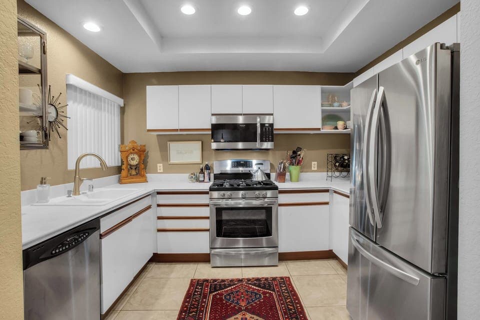 Fully equipped kitchen with stainless steel appliances and gas range