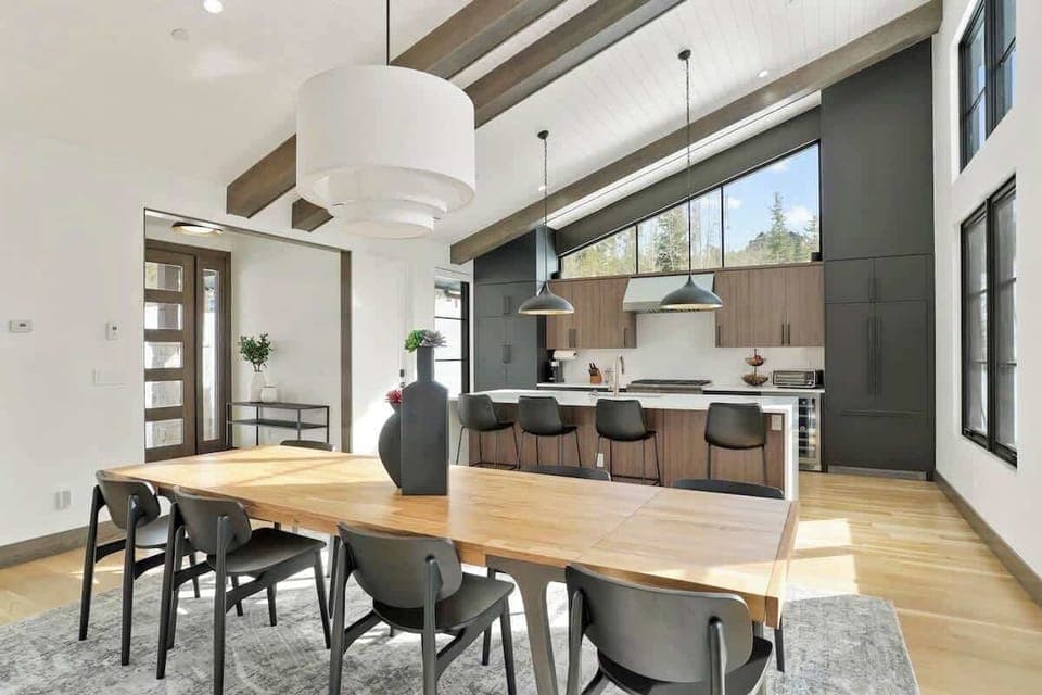 - Entertain with ease in our open-concept dining area and kitchen, featuring a spacious table for group gatherings. The modern design and high ceilings create an airy and sophisticated atmosphere.