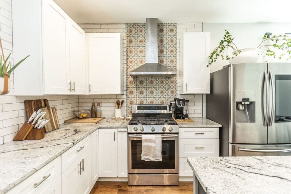 A spacious kitchen equipped with everything you need to cook: utensils, pots, pans, baking tools, bowls, spices, oil, tea, coffee, sugar, and all the basic kitchen supplies!