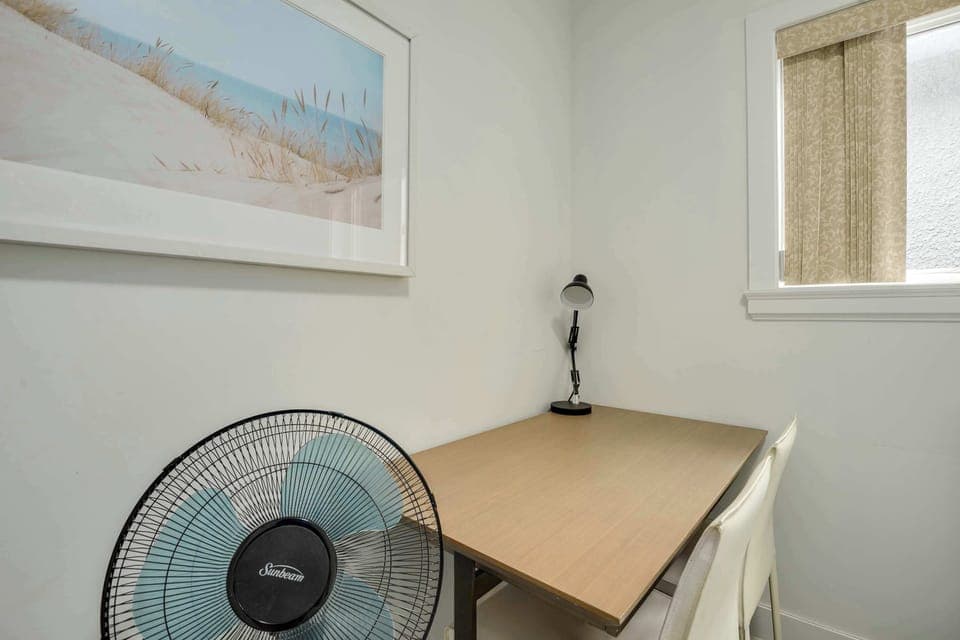 Dedicated workspace in a quiet corner, complete with a desk and lamp, ideal for productivity during your visit.