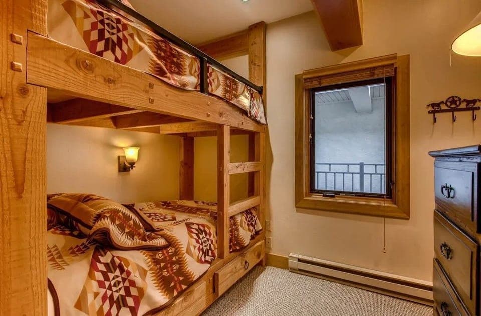 The bunk room, designed for fun and relaxation, combines stylish decor with warm colors, making it an ideal haven for kids after an adventurous day outdoors.