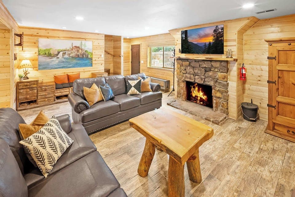 Elegant Living Area with huge LCD Smart TV' and natural log burning fireplace.
