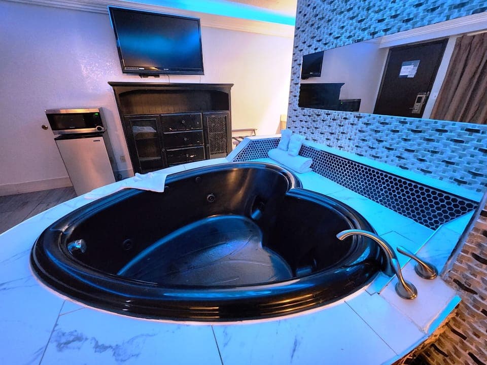 Suite, 1 King Bed, Non Smoking, Jetted Tub | Desk, laptop workspace, blackout drapes, iron/ironing board