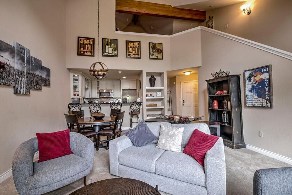 West Elm Loveseat and 2 chairs.  High ceilings and rich wood beams bring warmth.