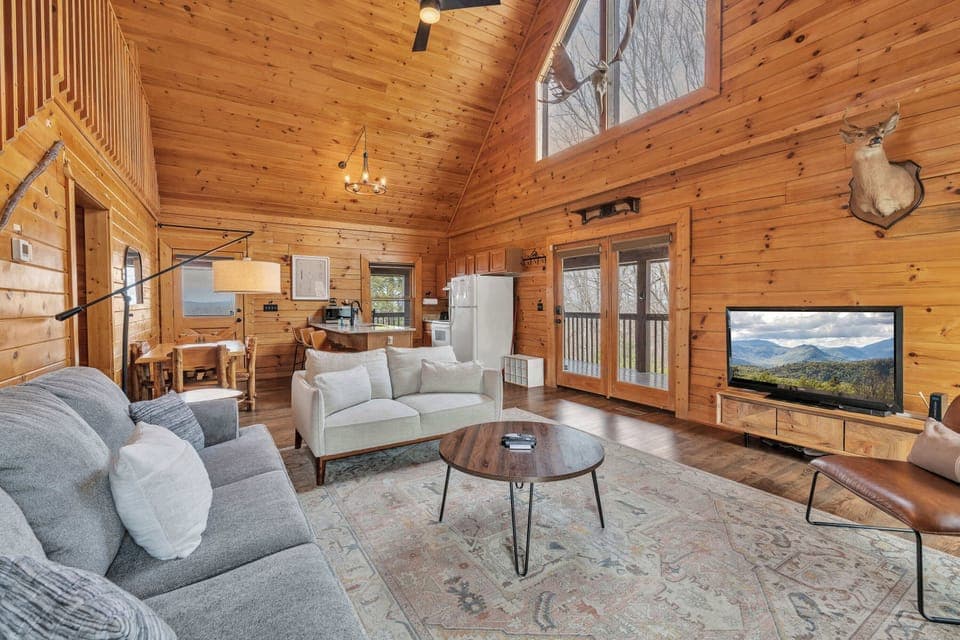 Spacious living area featuring generous seating, a Smart TV, and a cozy fireplace