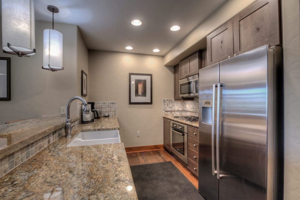 Kitchen with drip coffee maker, toaster, blender, slow cooker, and more