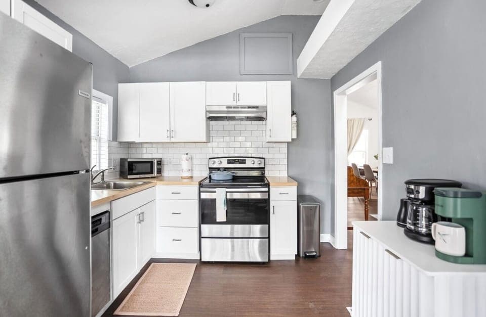 kitchen, stove, coffee maker, microwave, dishwasher, refrigerator. 