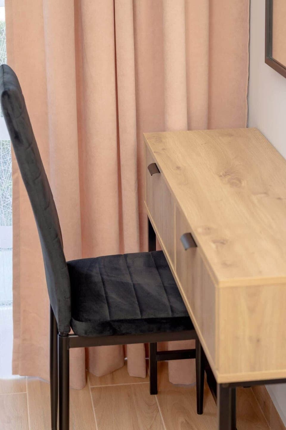 A simple, modern desk with wood and black elements, ideal for focused work or study.